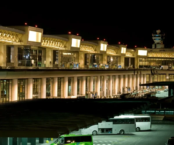 Illuminated Milan airport terminal serving Lodi transfers at night